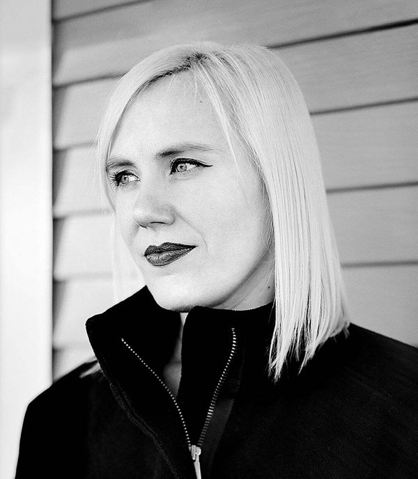 A close up black & white photograph of artist Patricia Barrett.