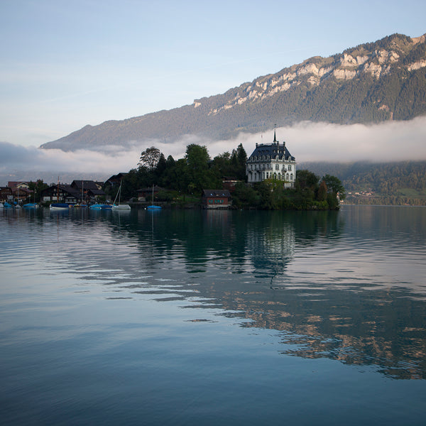 Interlaken, European lake with boats and mountain background